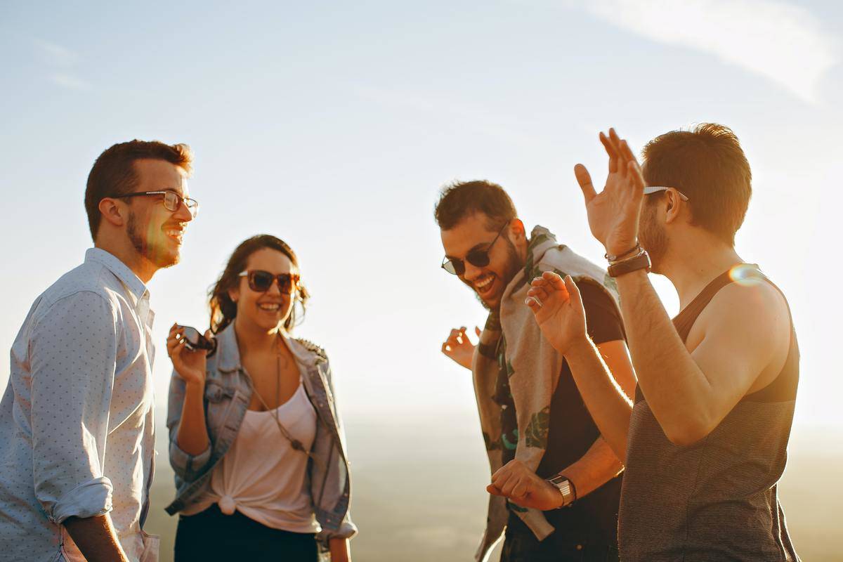 A group of friends smiling and laughing while spending time together.