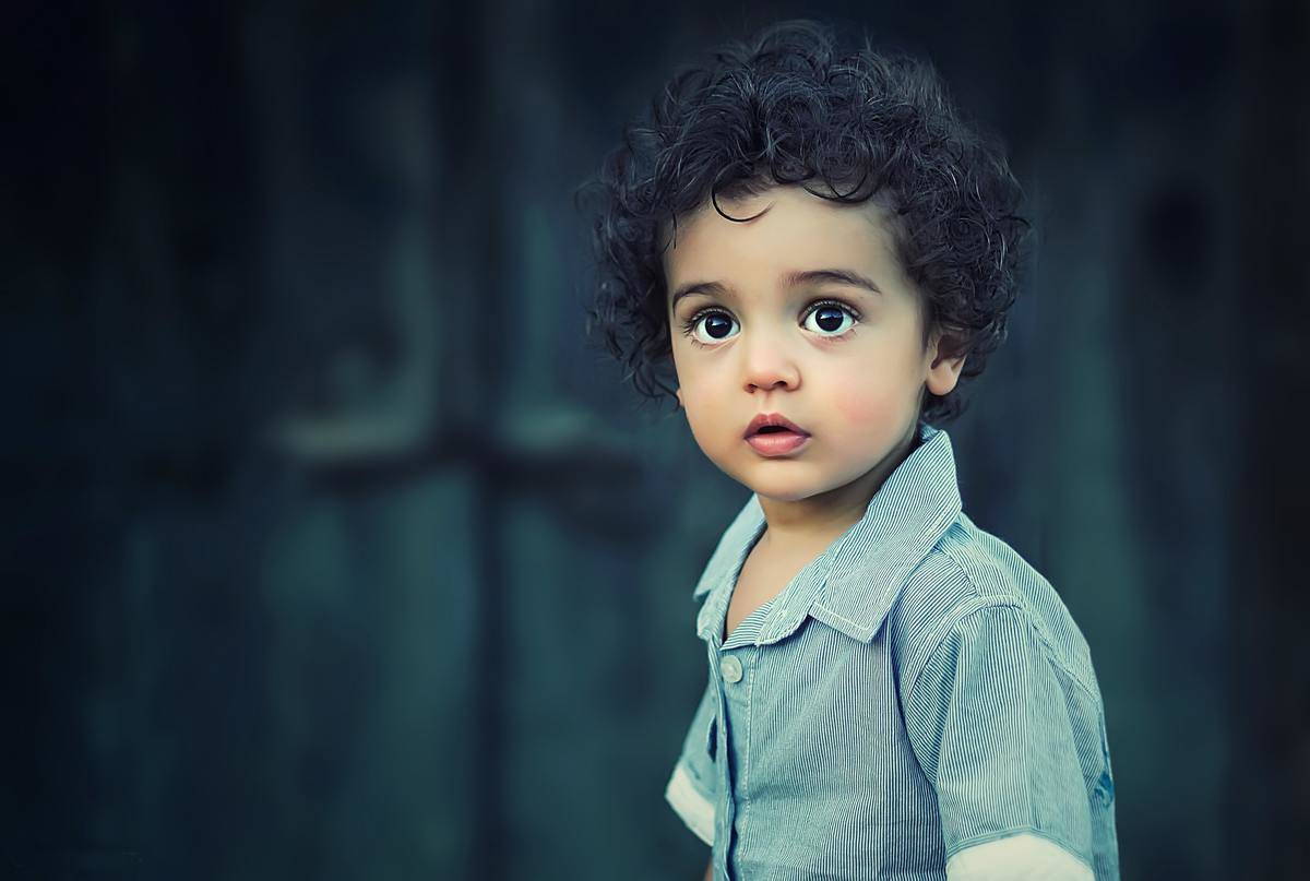 toddle-wearing-gray-button-collared-shirt-with-curly-hair-