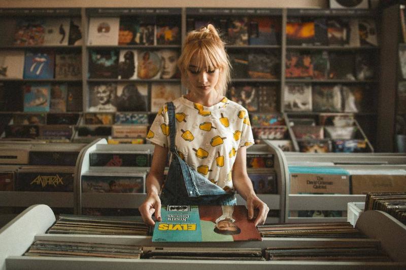 A girl browsing records in a record shop.