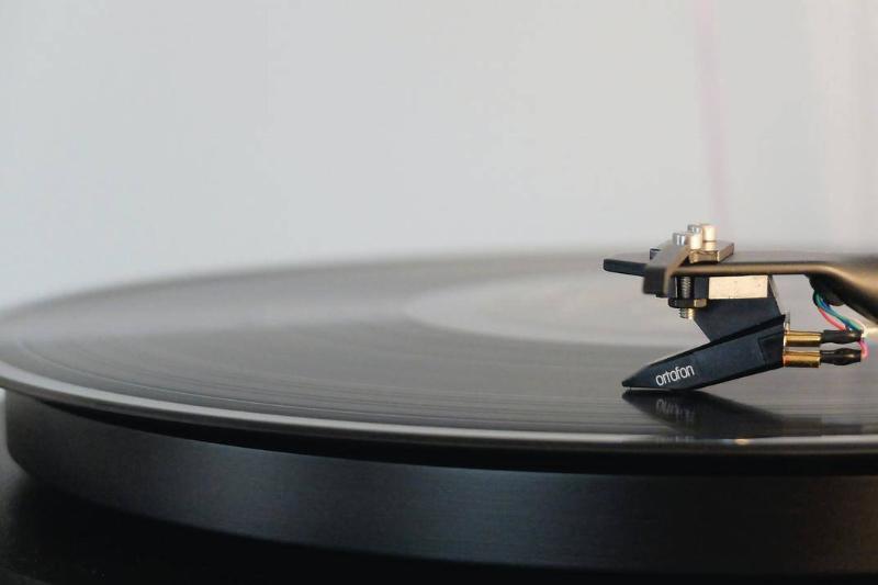 A closeup of a turntable needle on a record.