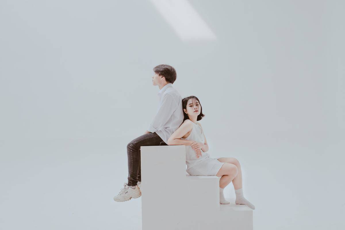 photo-of-woman-sitting-on-staircase-beside-man-