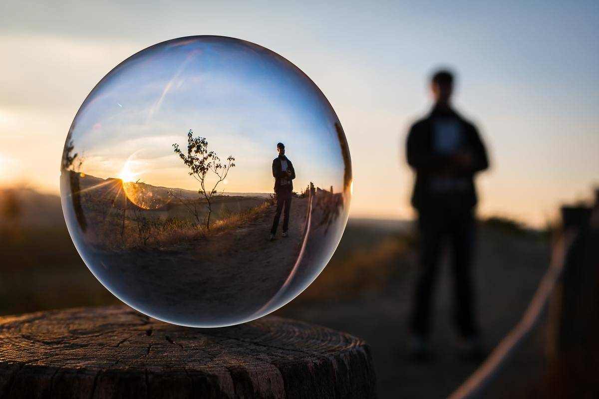 man stands with reflection on bubble