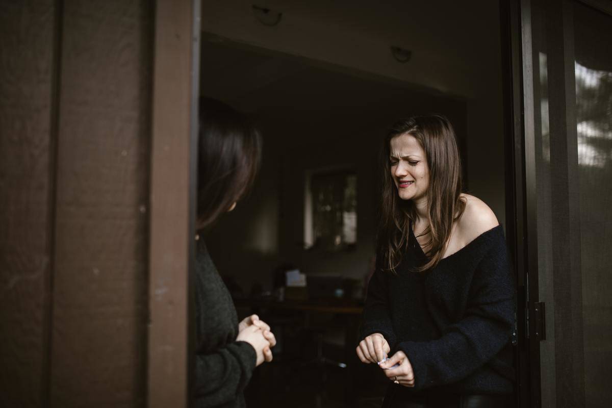 A woman crying as she speaks to her friend.