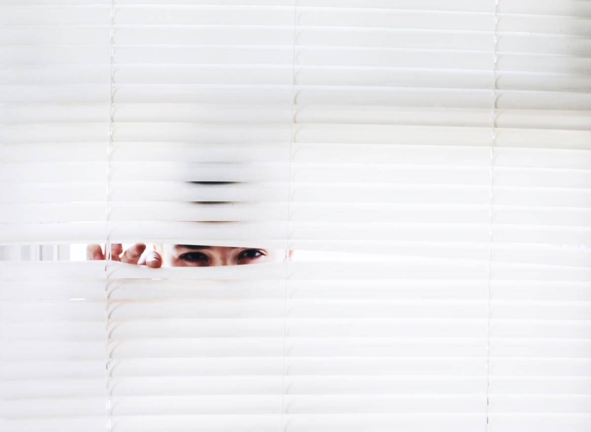photography-of-person-peeking-from blinds