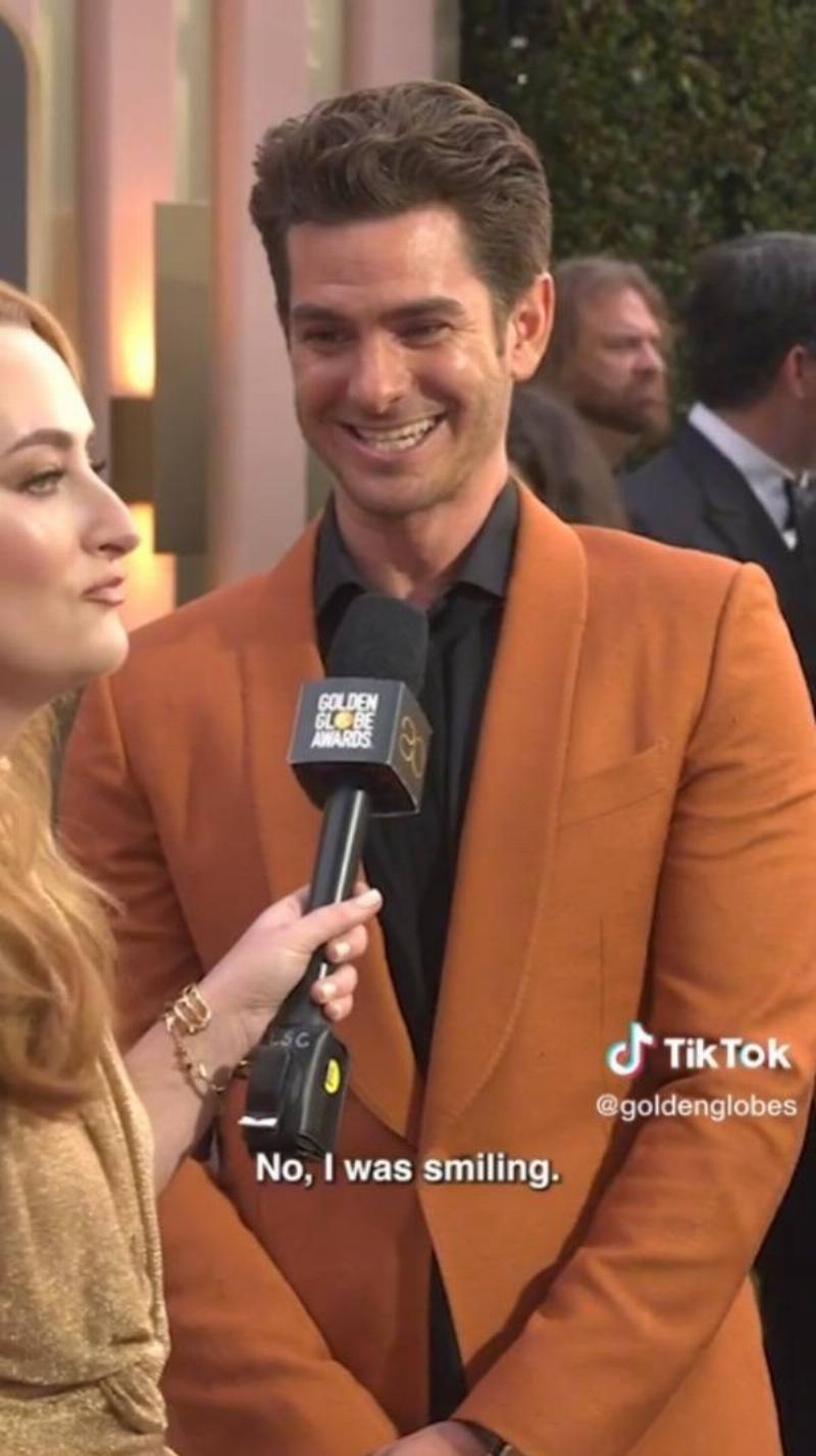 Andrew Garfiels smiling as he's being interviewed at The Golden Globes.