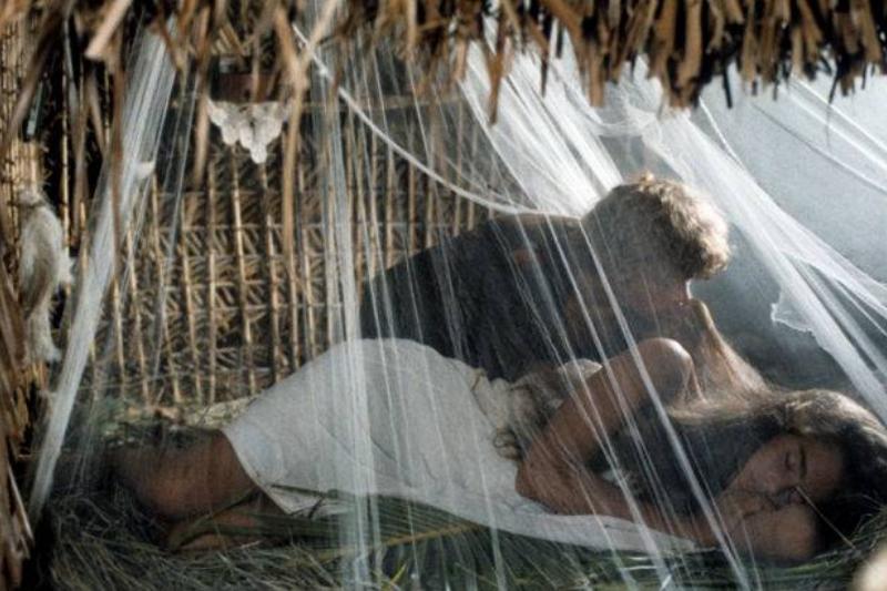 brooke shields and christopher atkins in blue lagoon scene lying in wood hut