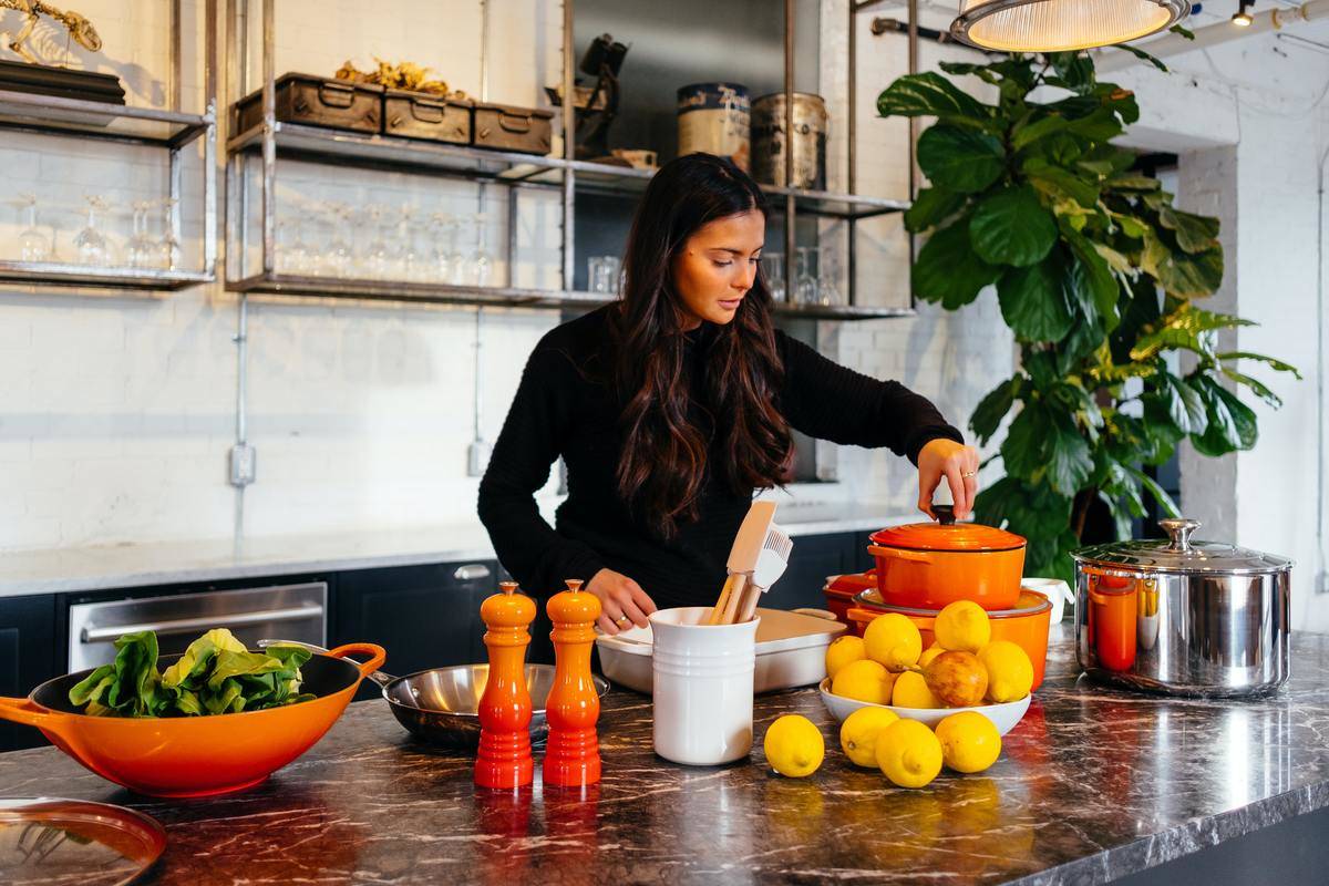 A woman cooking a healthy meal in her kitchen.