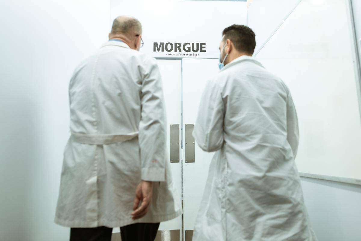 Two workers walking into a morgue.