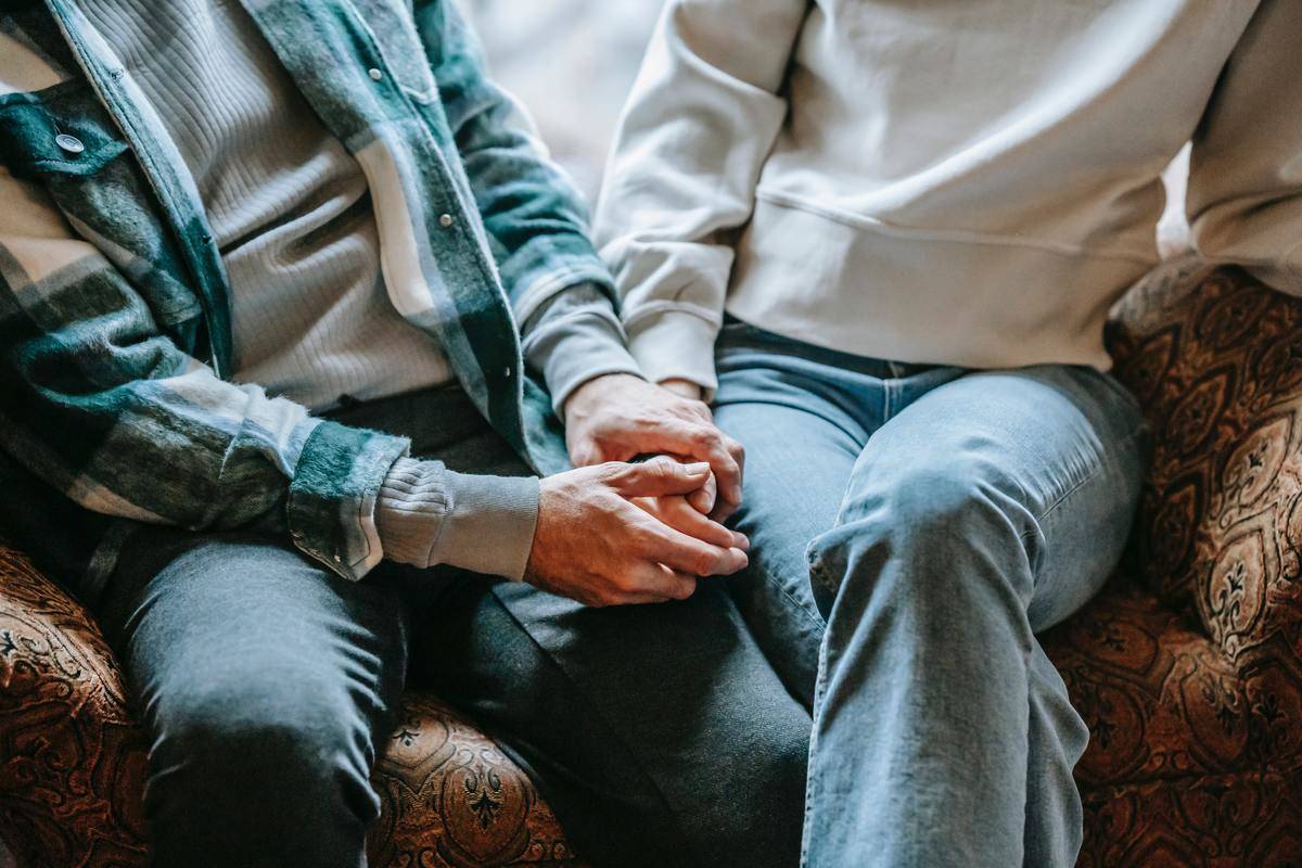 An older couple holding hands.