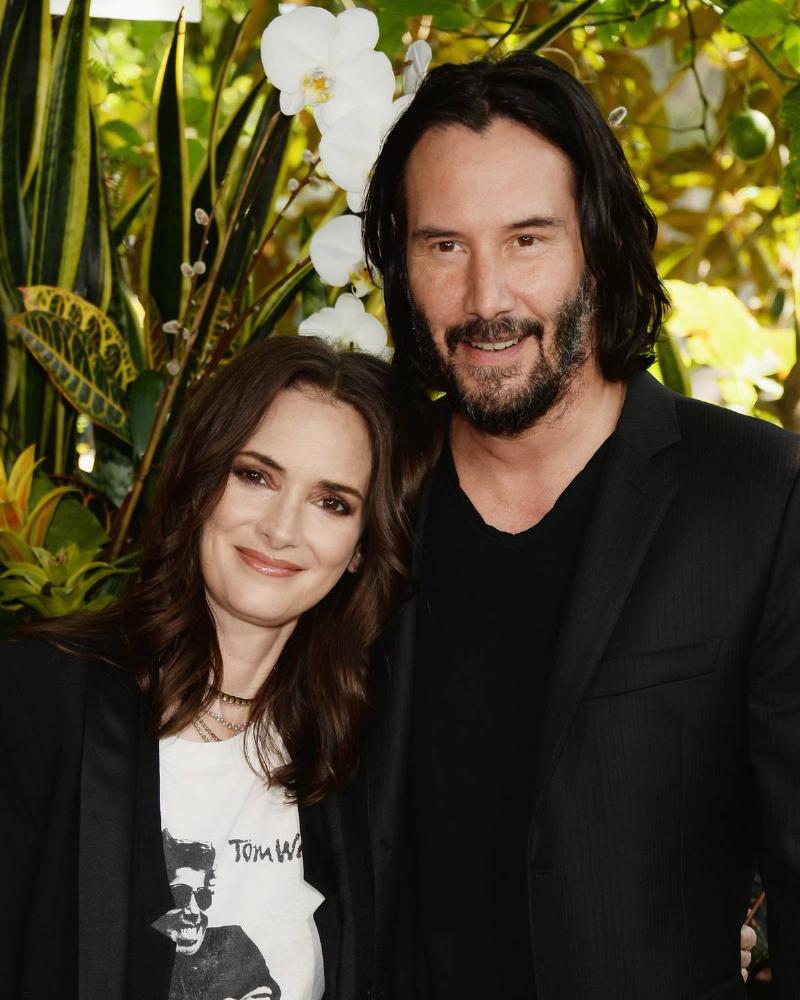 Winona ryder and keanue reeves posing at hotel in 2018