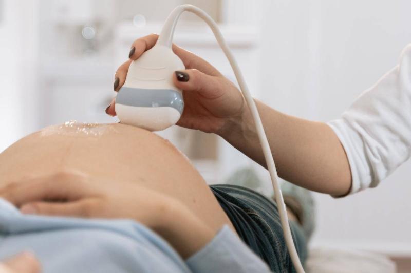 A pregnant woman receiving an ultrasound.