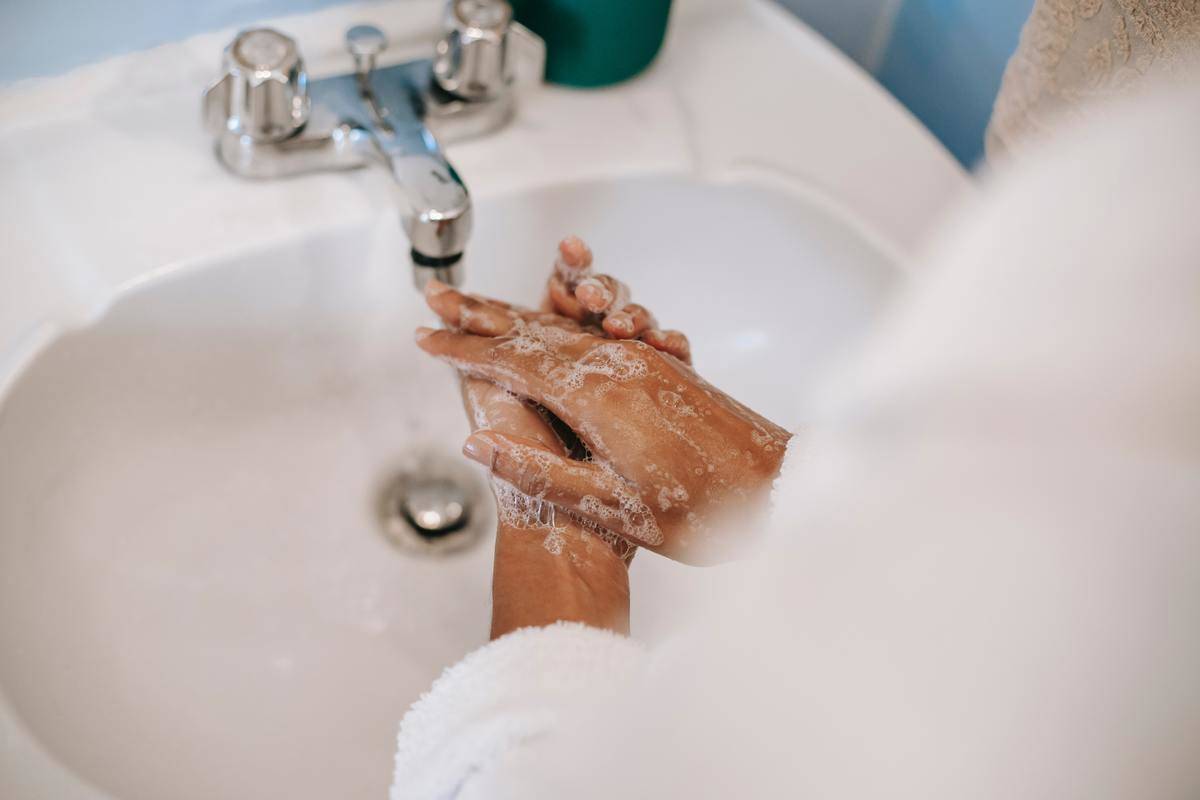 Someone washing their hands in the sink.