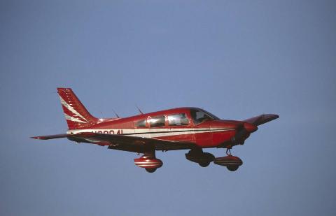 Red Piper PA-28 Cherokee flying enroute.