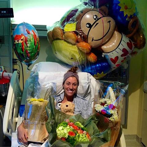 Brittany Williams when she was recovering in the hospital, surrounded by flowers and balloons. 