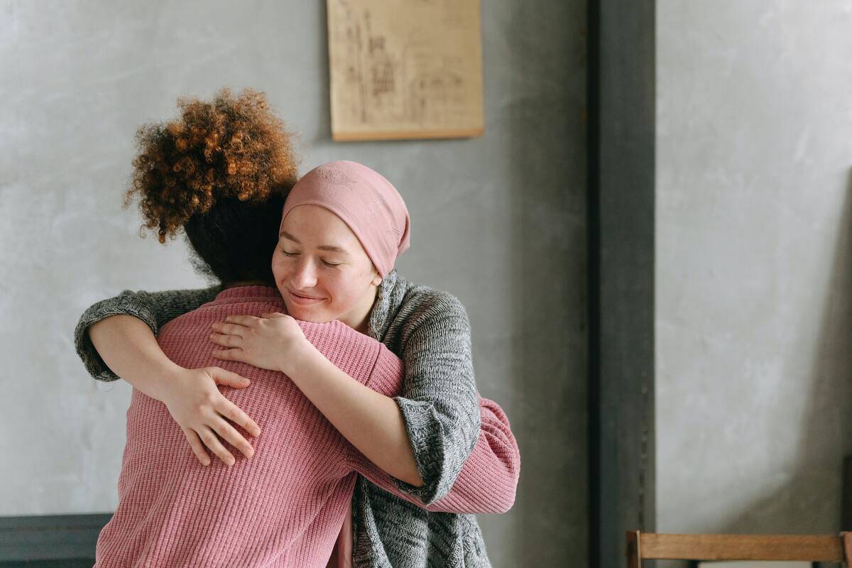 Two friends sharing a supportive hug.