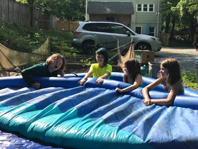 Four of the kids in the inflatable pool.