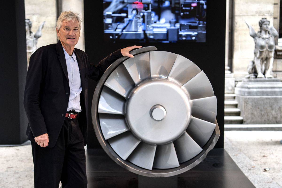 British industrial design engineer and founder of the Dyson company, James Dyson, poses next to the model of an engine during a photo session at a hotel in Paris on October 11, 2018.