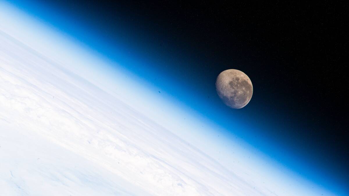 A NASA image of the moon above Earth's surface.