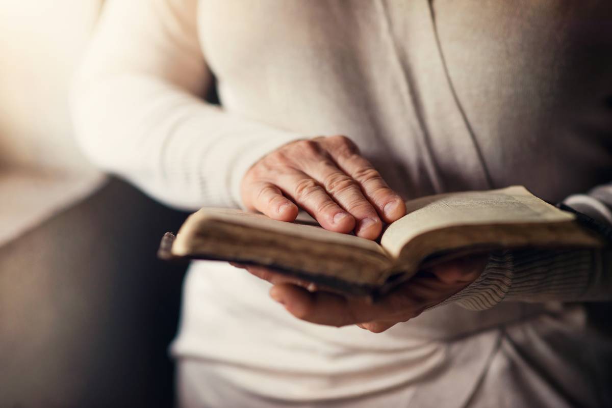 A woman holding a bible open.