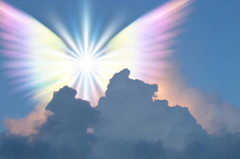 cloudy sky with multicolored bright light in center of sky that resembles an angel