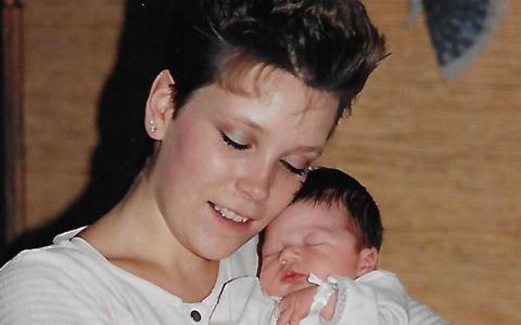 Rachel's mom holding her when she was newly born, before putting her up for adoption.