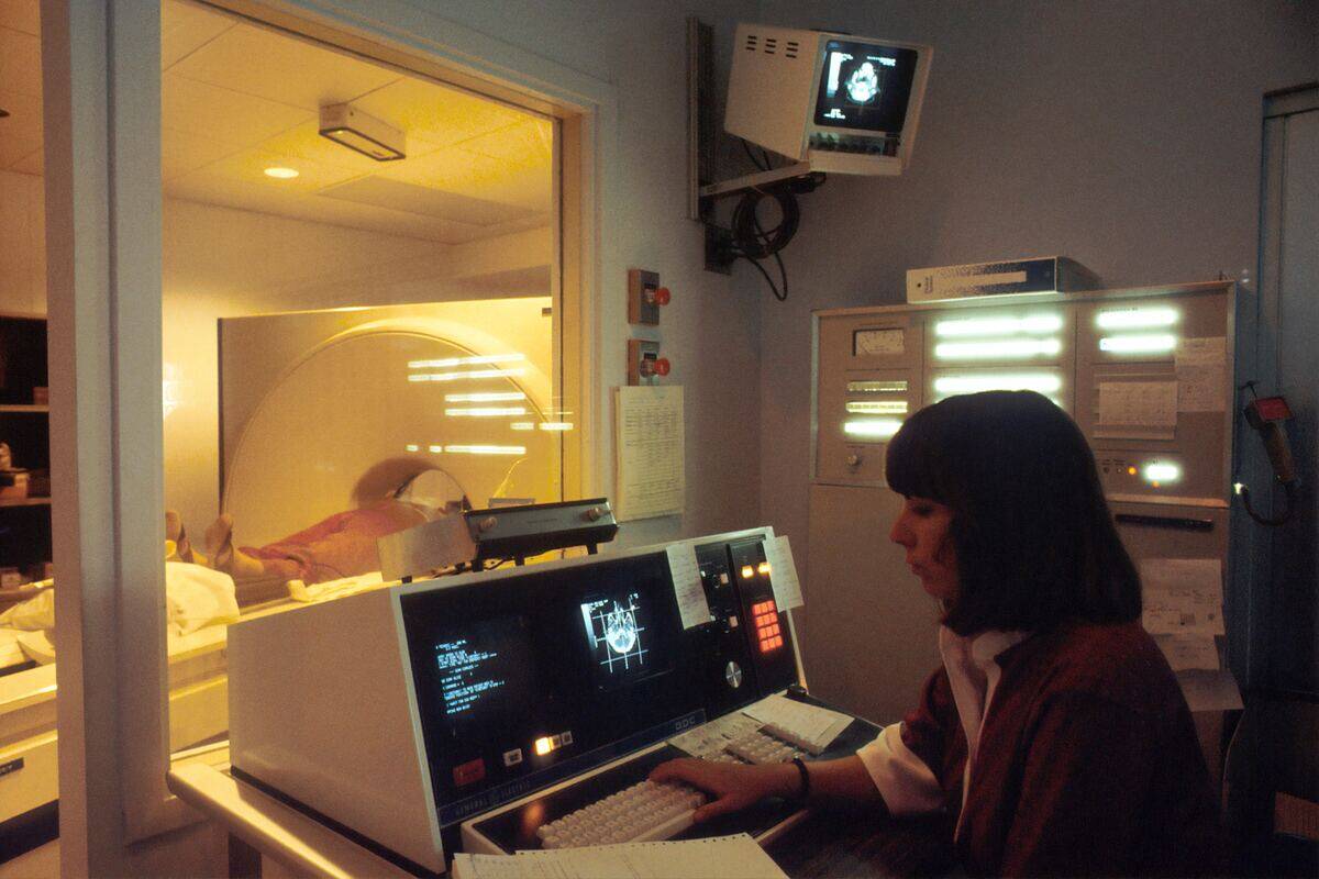 A woman reading the results from an active MRI scan.