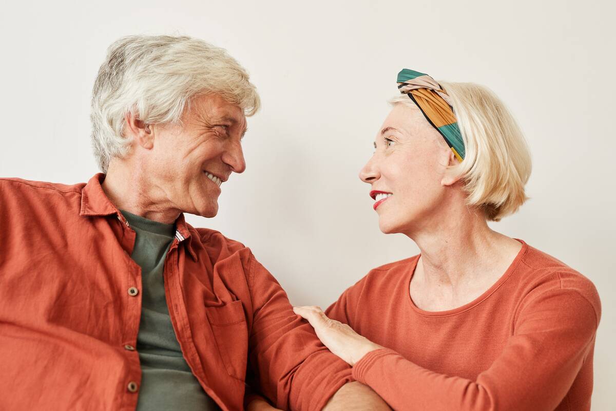 Mature couple talking to each other against the white background