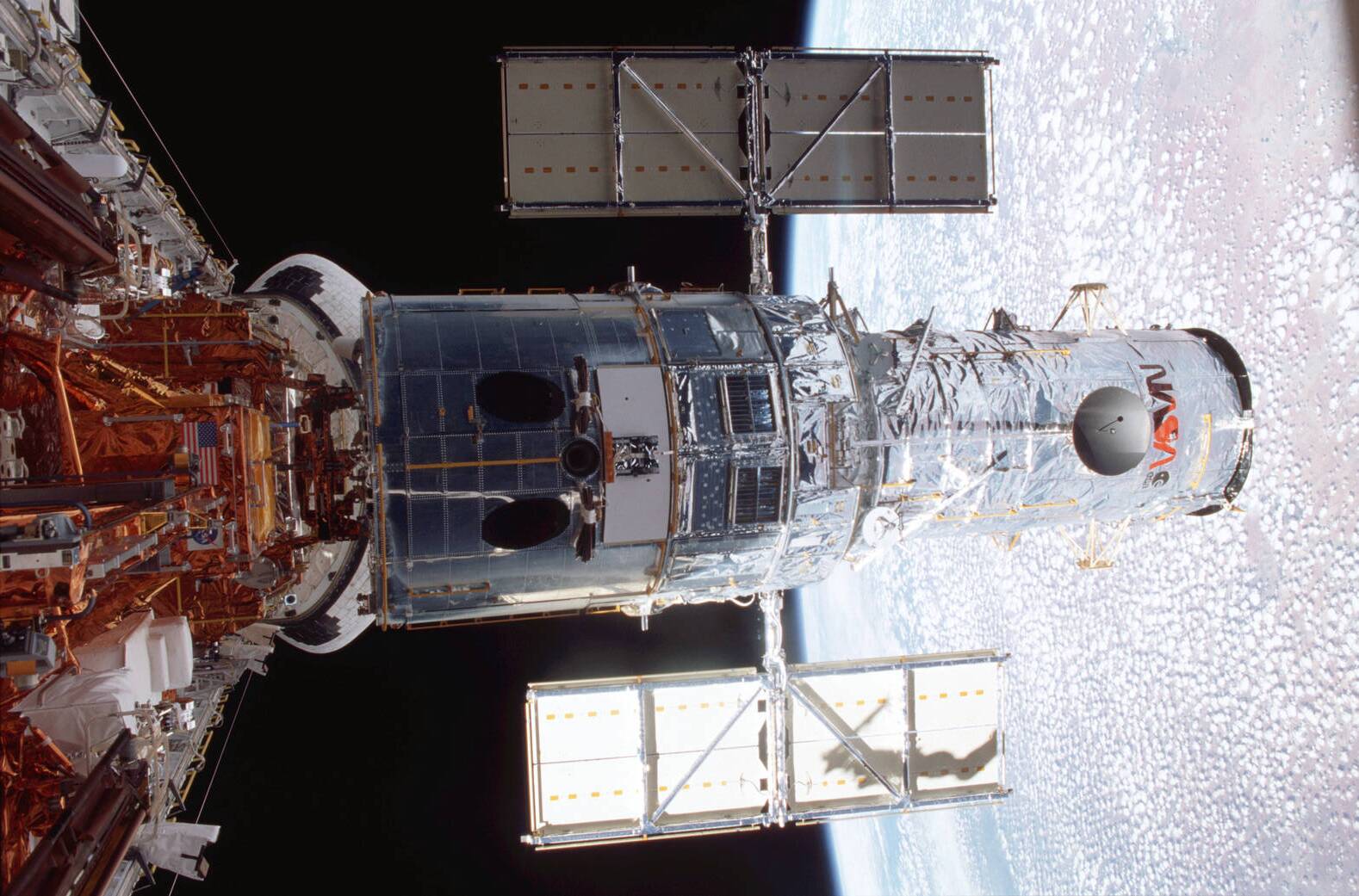 The Hubble Space Telescope as it flies through space.