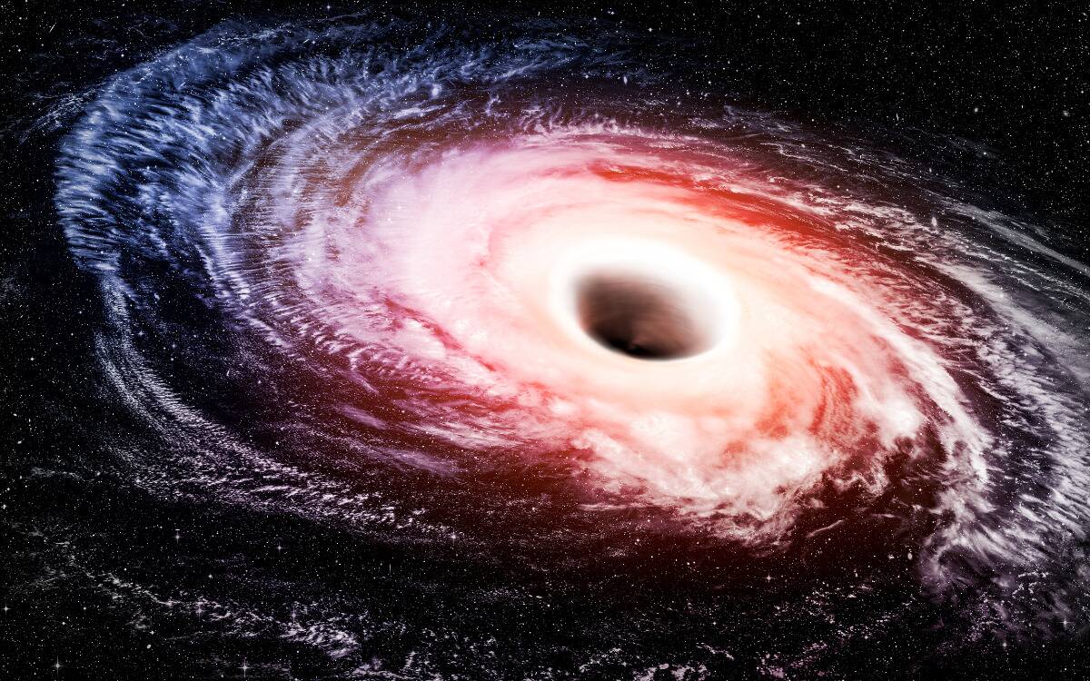 A render of a black hole that resembles a hurricane, with oranges near its centre and blues around the outside.
