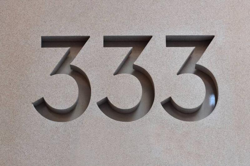 333 carved into stone slab