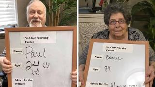 Two residents holding up their advice signs.