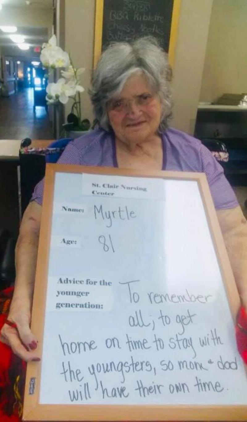 Myrtle holding her sign.