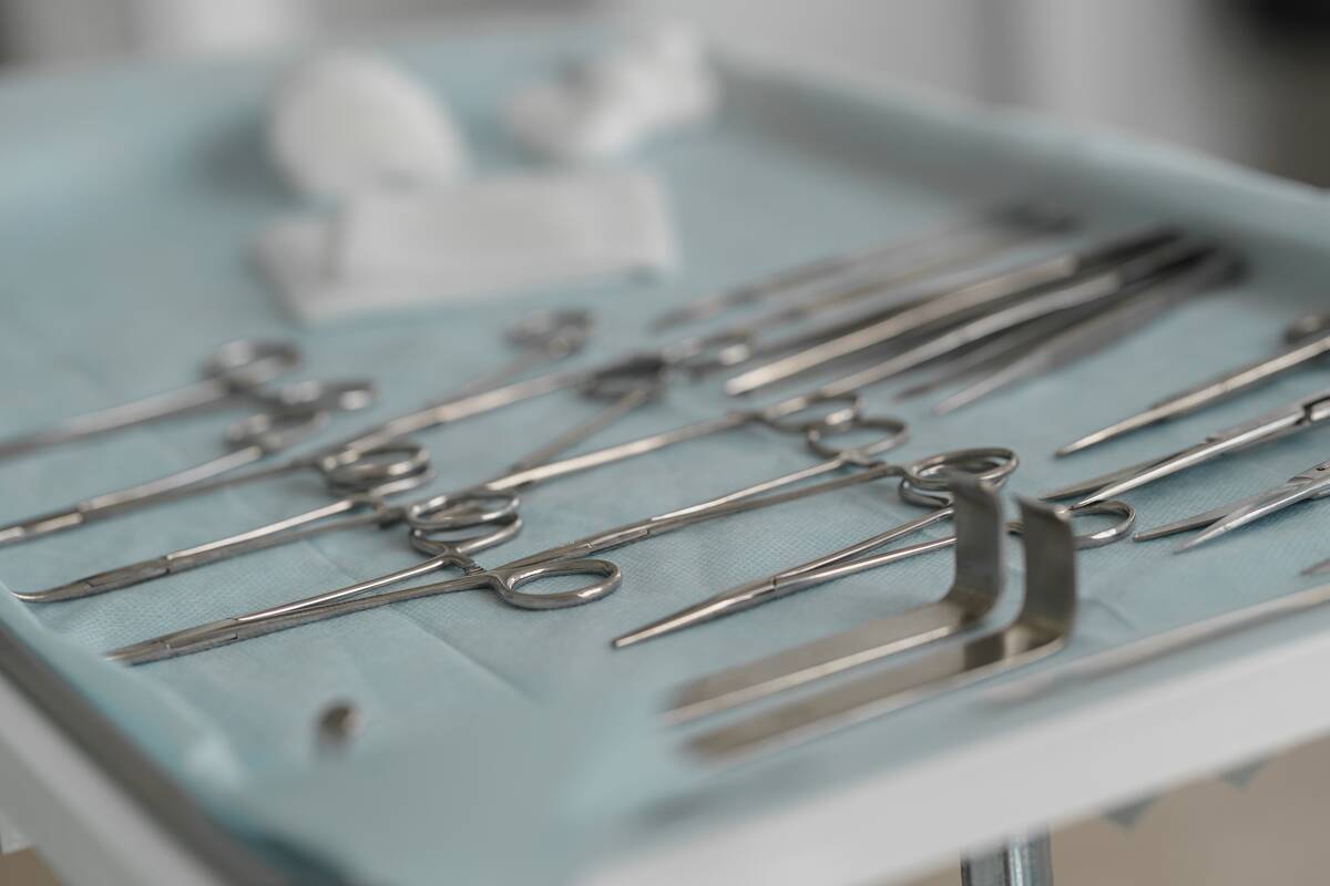 Instruments and tools including scalpels forceps and tweezers arranged on table for surgery