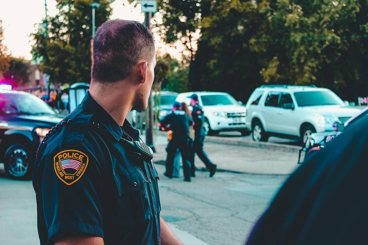 A police officer looking over his shoulder at other officers walking by.