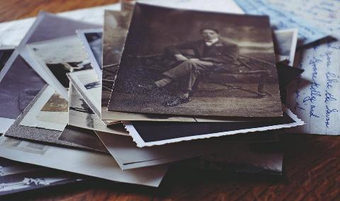 A stack of old, vintage photographs.