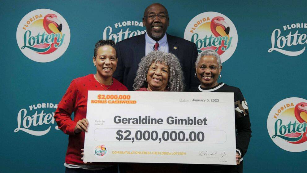 The Gimblet family picking up their winning lottery check.