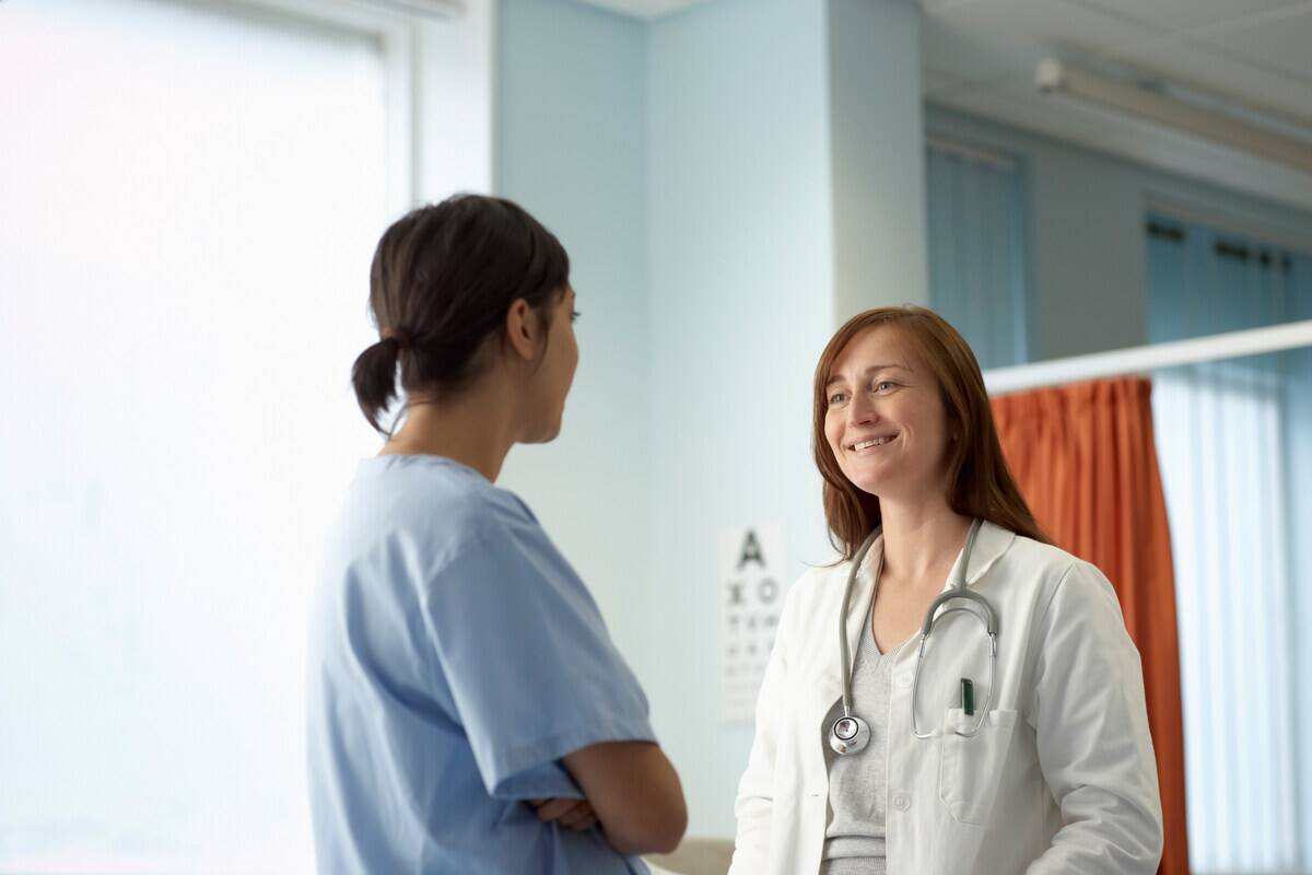 Two people, nurse and doctor in discussion.