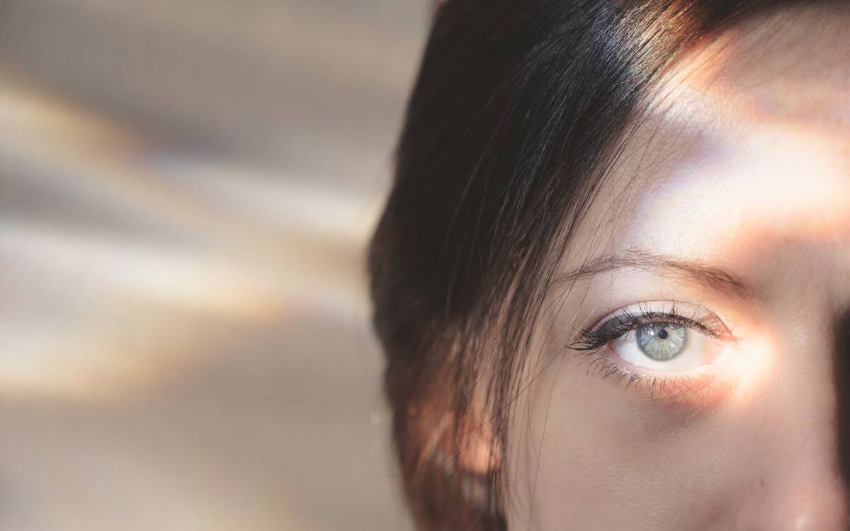 A closeup of a woman's eye in bright light.