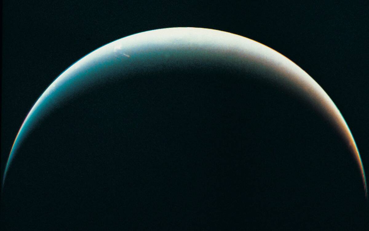 The silhouetted horizon of Neptune.
