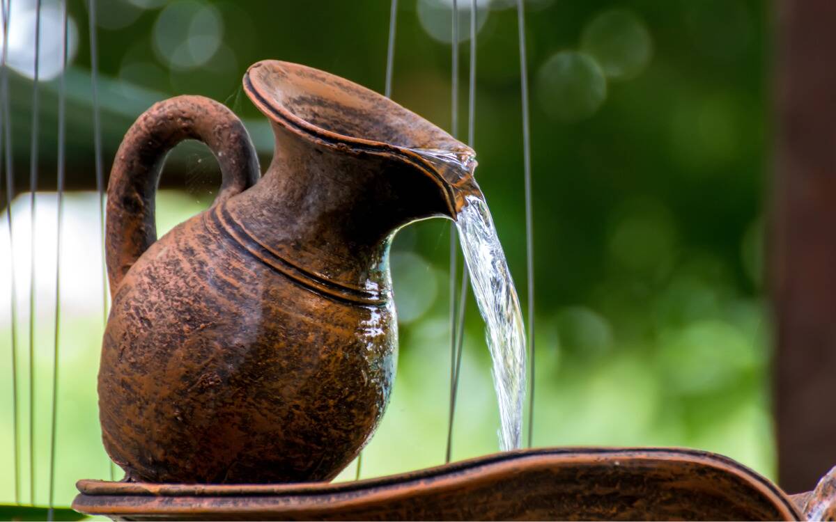 A fountain in the shape of a water jug pouring water out.