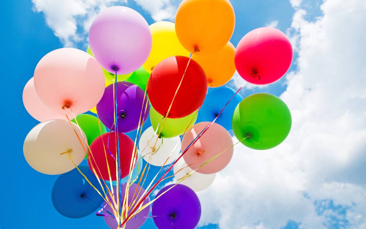 Colorful balloons against a bright blue sky.