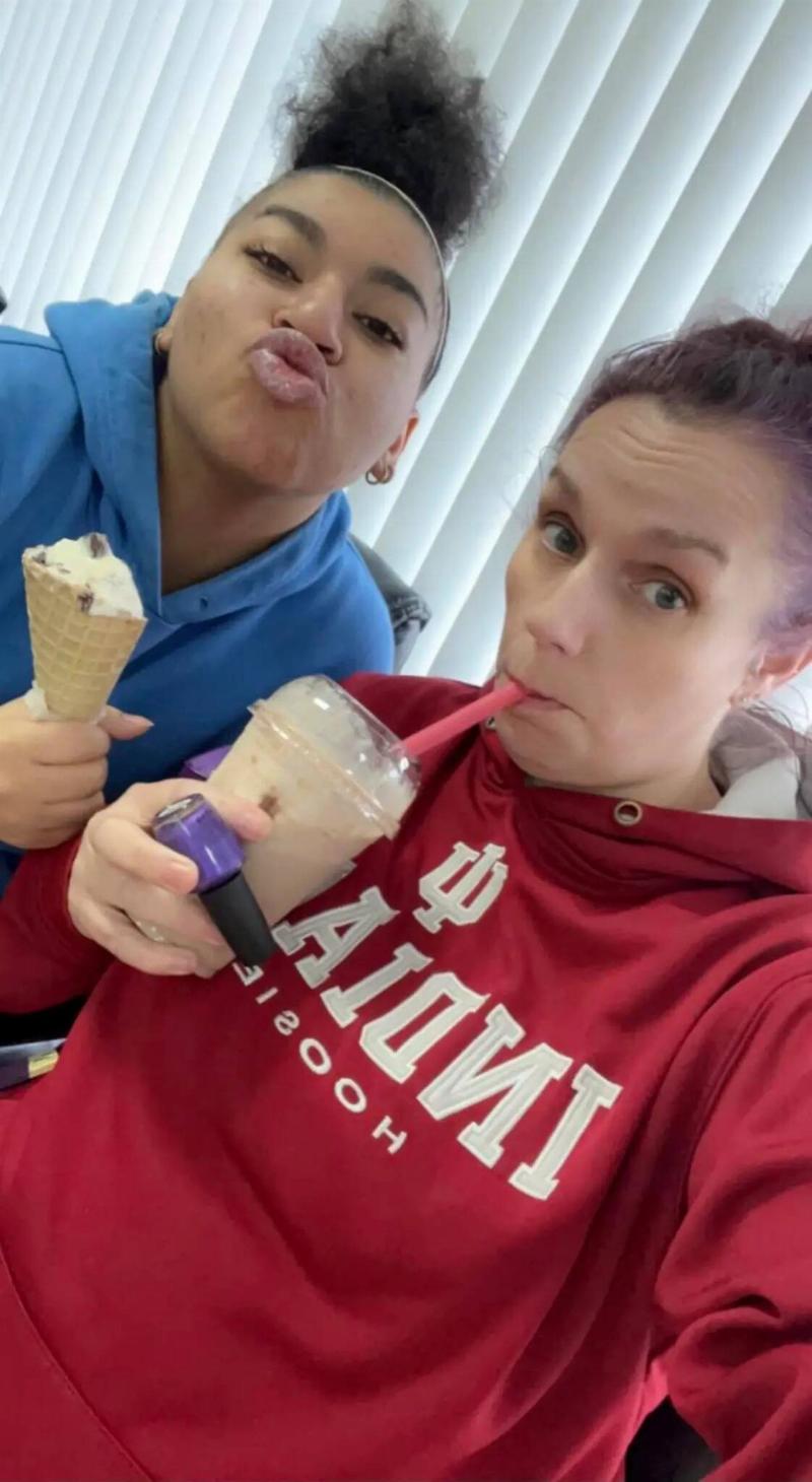 Small and Mullen enjoying some ice cream together, Mullen taking a selfie of them both.