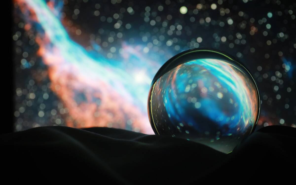 A photo of a galaxy warped in a glass bead.
