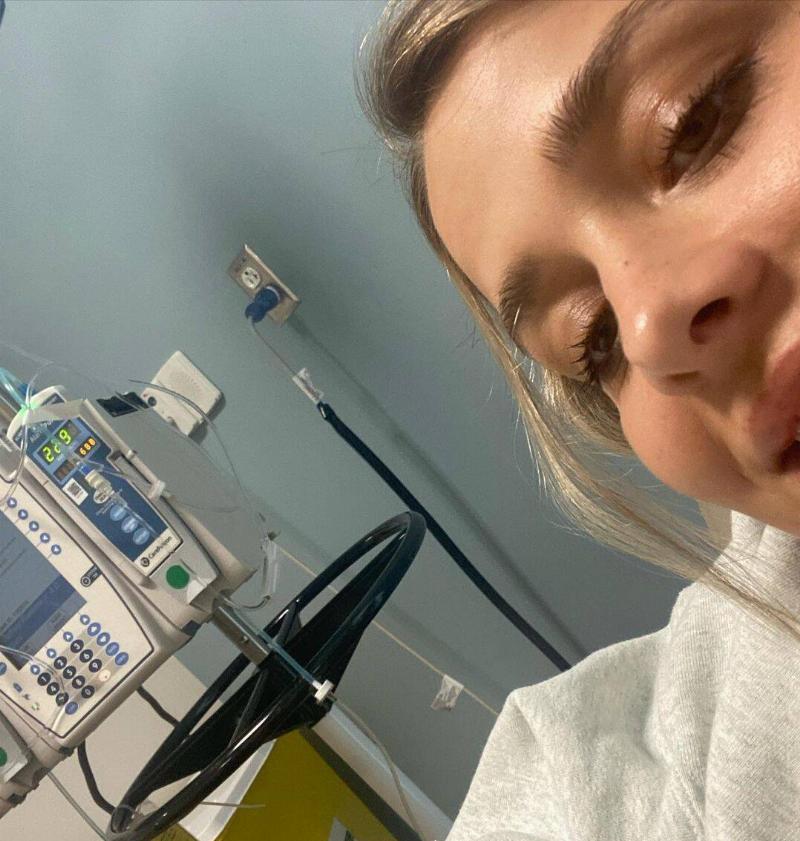 Bailey in the hospital with an IV device next to her.