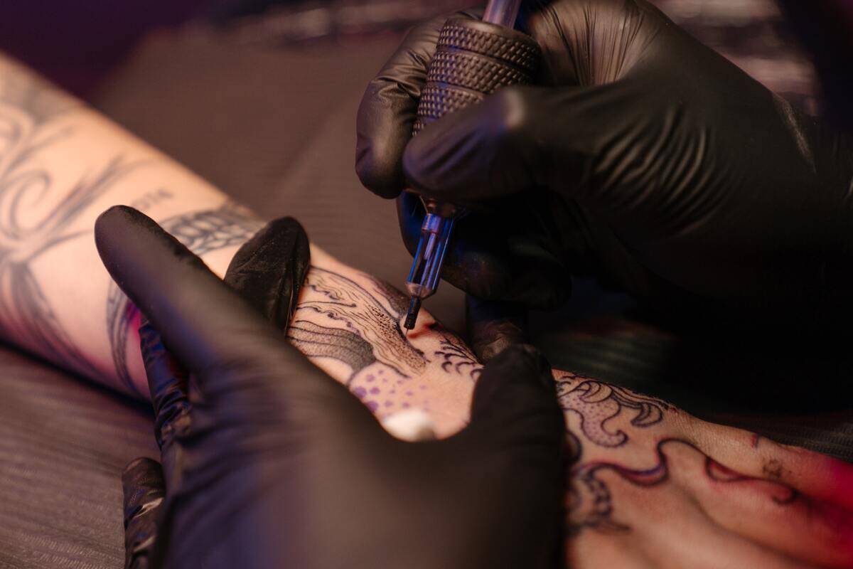 Someone getting their arm tattooed.