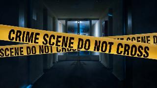 Yellow 'Crime Scene Do Not Cross' tape over a darkened hallway.