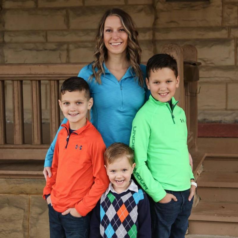 Rebecca posing with her three sons.