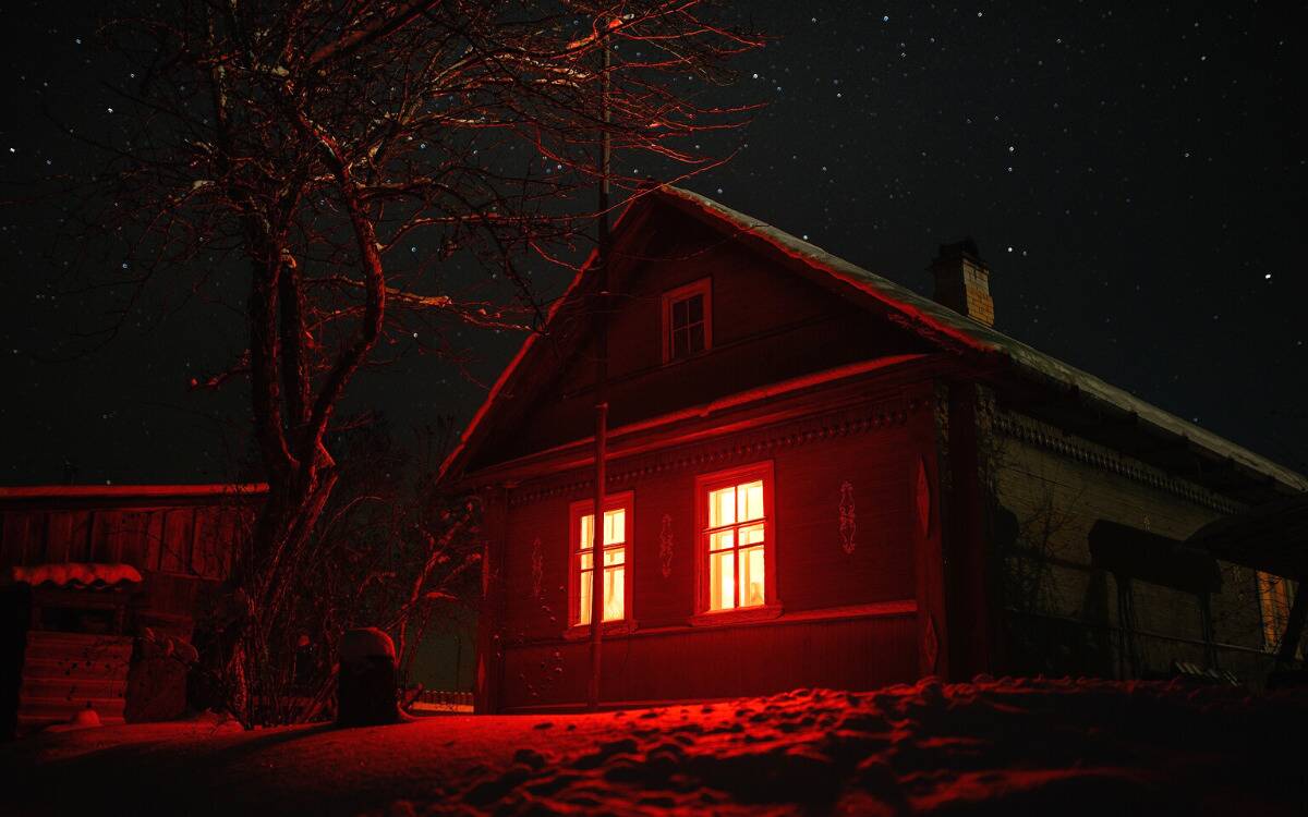 A house with bright red lights shining from the inside.