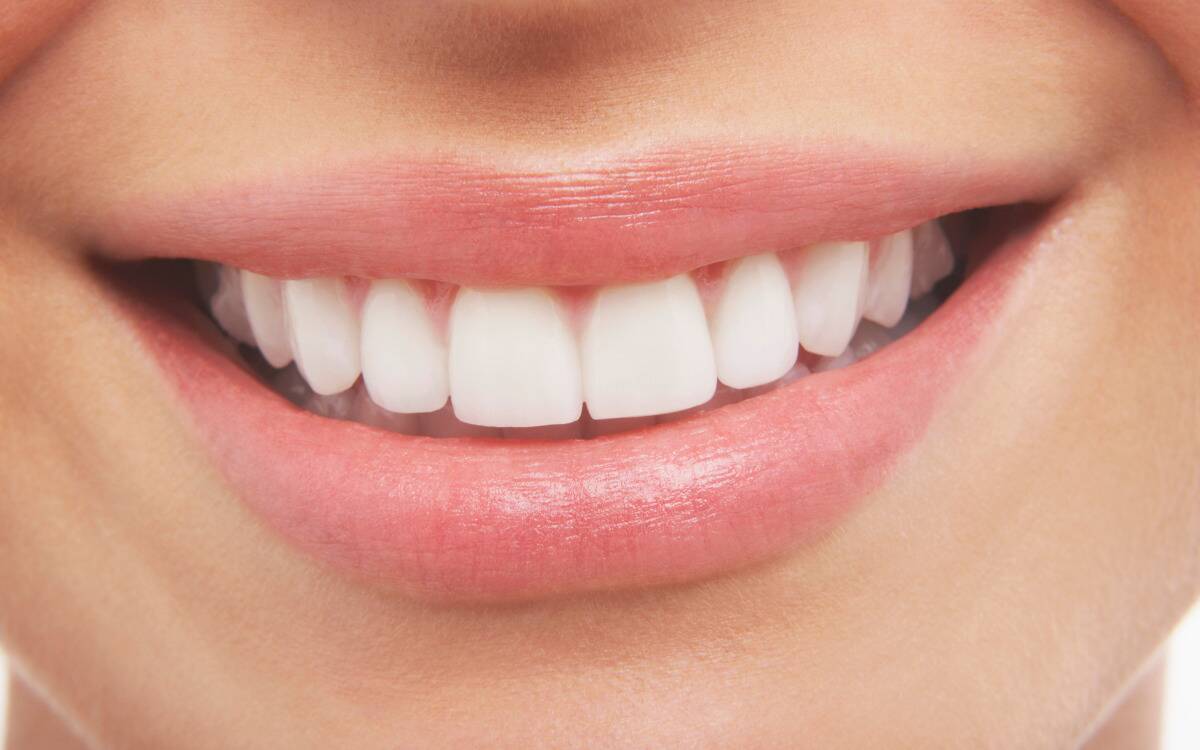 A closeup of someone's smiling mouth.