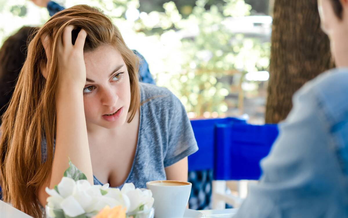 A woman looking exasperated during a date.